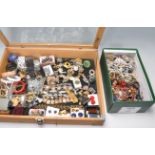 A collection of vintage costume jewellery all set within a wooden glazed top display case to include