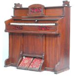 A late Victorian 19th century chapel harmonium organ. The mahogany case with simple carved detail,