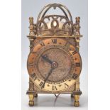 An early 20th century electric Smiths brass lantern clock with pierced gallery top, electric