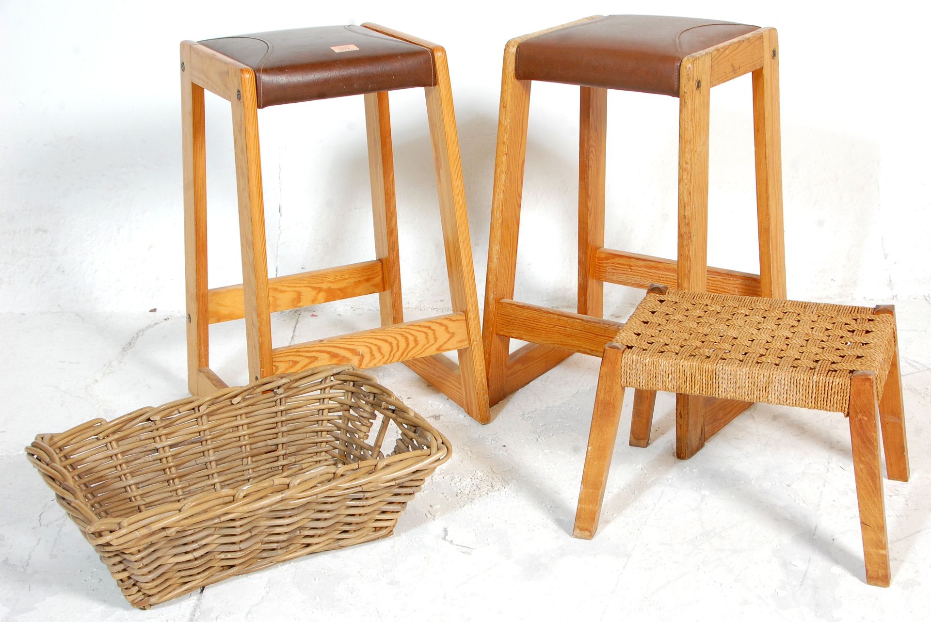 A collection of vintage stools to include two retro 1980's wooden and brown leather stitched seat