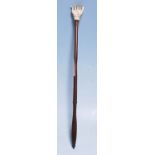 A 19th Century Victorian back scratcher having a carved bone hand scratcher on a turned dark wood