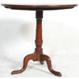 An 18th century George III country oak pedestal tilt top wine / occasional table. Raised on a