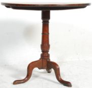 An 18th century George III country oak pedestal tilt top wine / occasional table. Raised on a