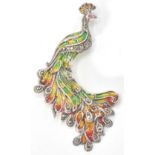 A 20th century art nouveau style sterling silver and plique a jour brooch in the form of a peacock