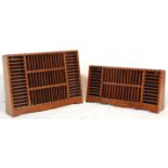 Two inlaid Indian hardwood tape racks having vertical and horizontal slots with decorative brass