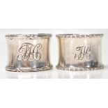 Two silver hallmarked napkin rings to include one with gadrooned borders and engraved initials to