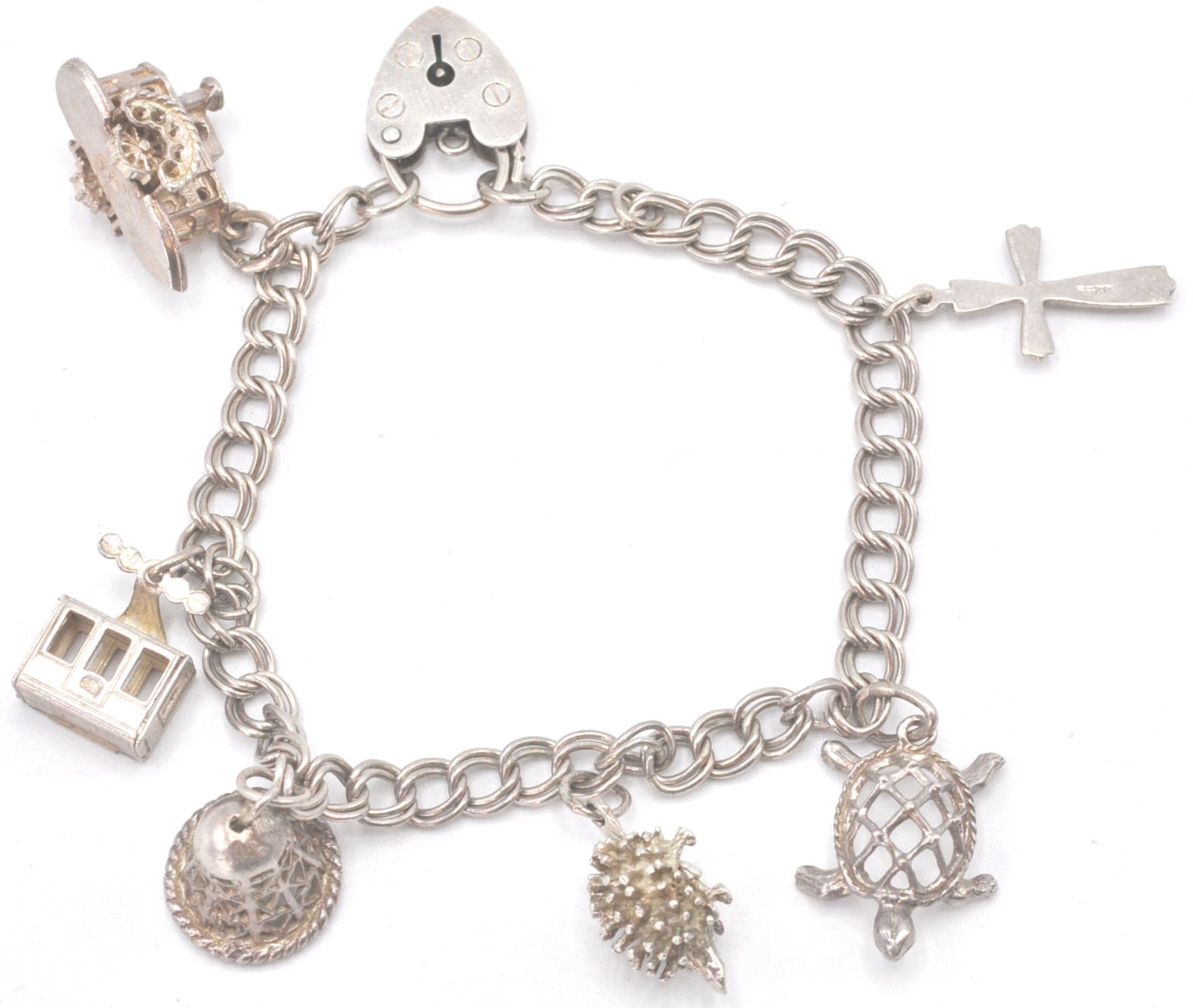 A contemporary hallmarked sterling silver charm bracelet with charms in the shape of a heart