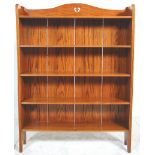 A 19th century Victorian golden oak Arts & Crafts open window bookcase. Raised on arched supports