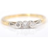 An 18ct gold, diamond and platinum ring. The ring with 3  round cut diamonds in prong setting to
