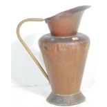 A late 19th / early 20th Century large copper jug having a tapering body with a round base and