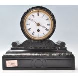 A late 19th Century black marble barrel mantel clock having a plinth base with round clock mounted