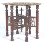 An early 20th Century Indian brass topped Benares table  having a scalloped edge top with