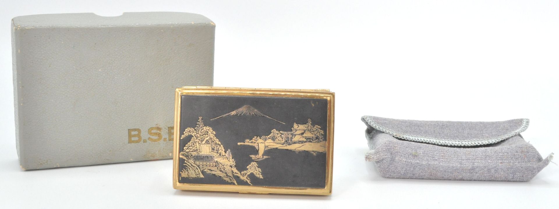 A good vintage 20th Century musical compact by B.S.B having a Japanese scene atop with mount Fuji in