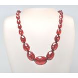 A Victorian Bakelite / early plastic faceted cherry necklace of graduating form. Beads measure