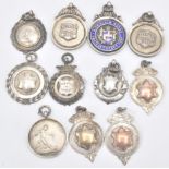 A group of eleven silver hallmarked fobs to include 9ct gold fronted examples, football fob medal,