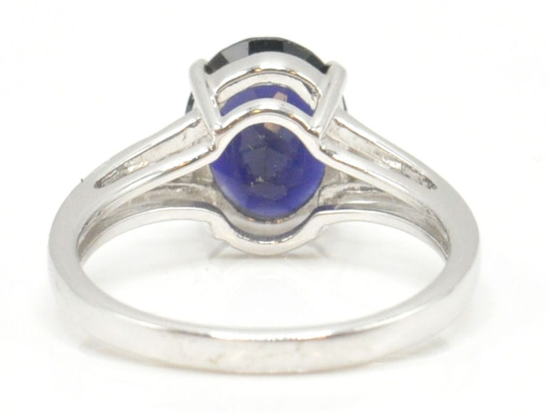 A 9ct white gold and blue oval cut single stone ring in prong setting being hallmarked for - Image 12 of 15
