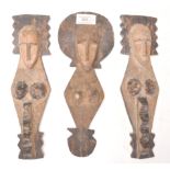 A group of three African tribal carved fertility figures / wall plaques having elongated faces
