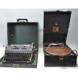 A vintage 20th Century Olympia typewriter having a black matte ebonised metal body with black typing