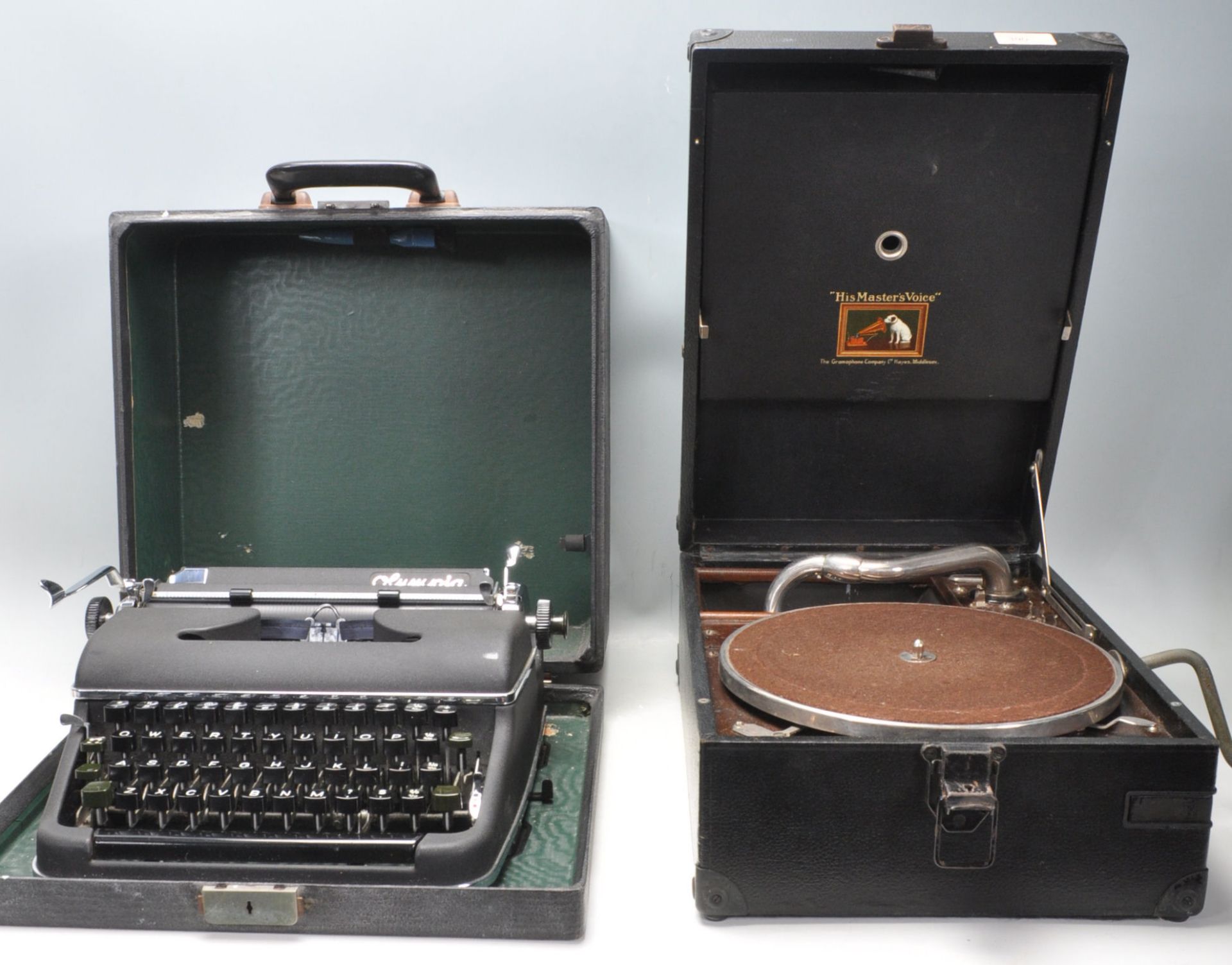 A vintage 20th Century Olympia typewriter having a black matte ebonised metal body with black typing