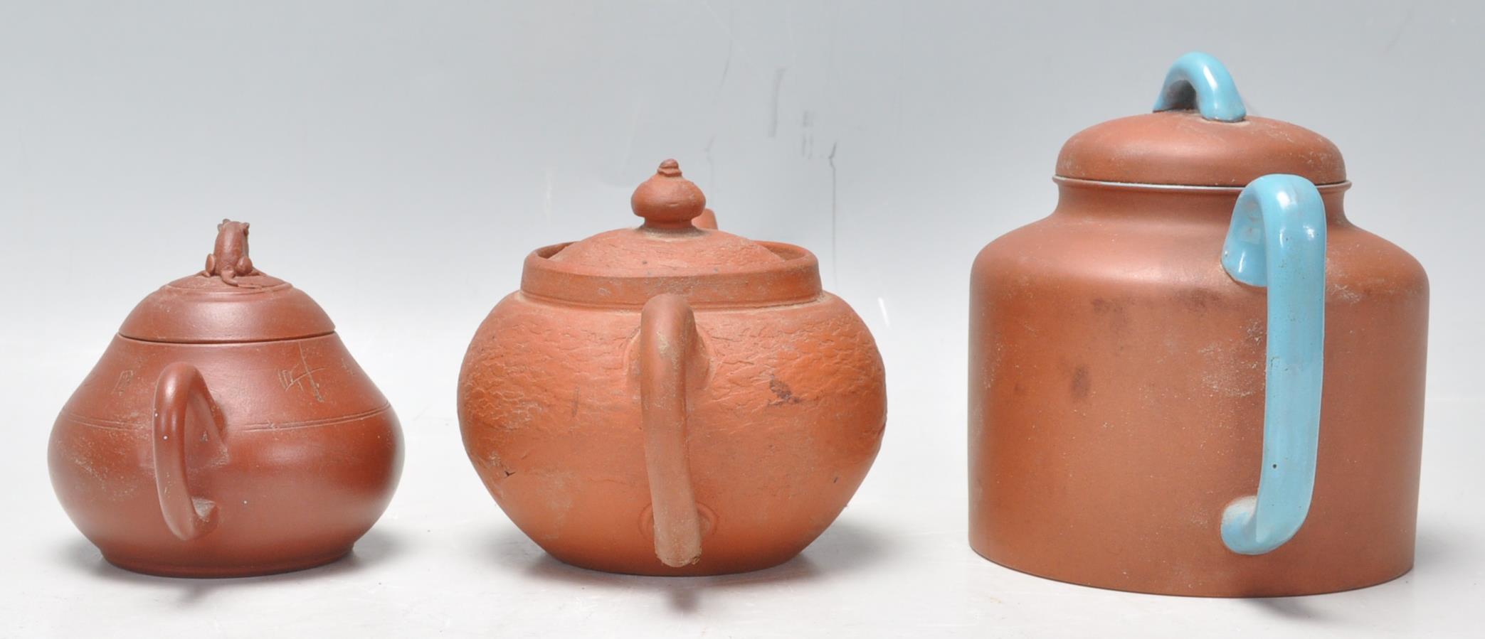 A collection of Chinese yixing teapots each of red clay terracotta form. To include a cylindrical - Image 4 of 12