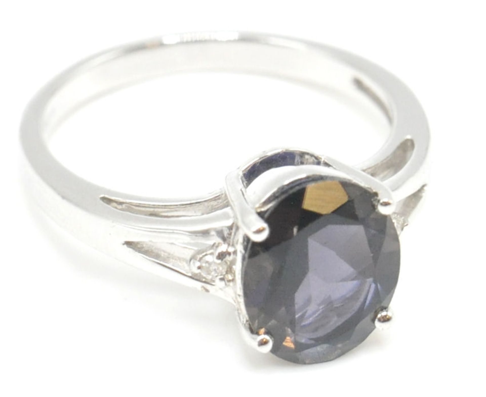 A 9ct white gold and blue oval cut single stone ring in prong setting being hallmarked for - Image 10 of 15
