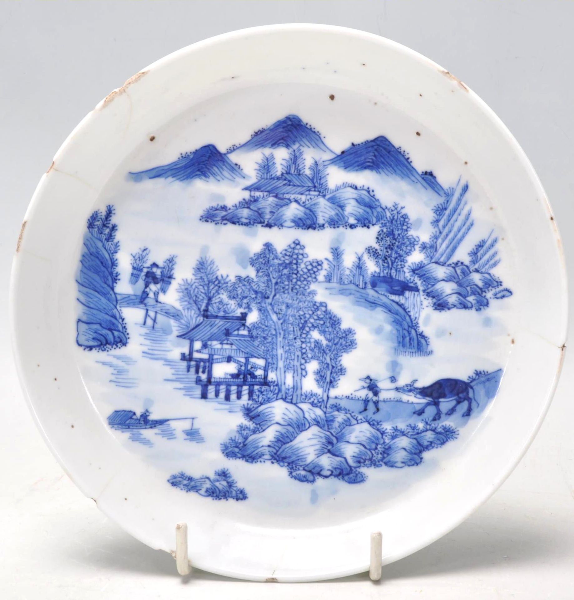 An 18th Century Kangxi Chinese blue and white hand painted dish of round form being finely painted
