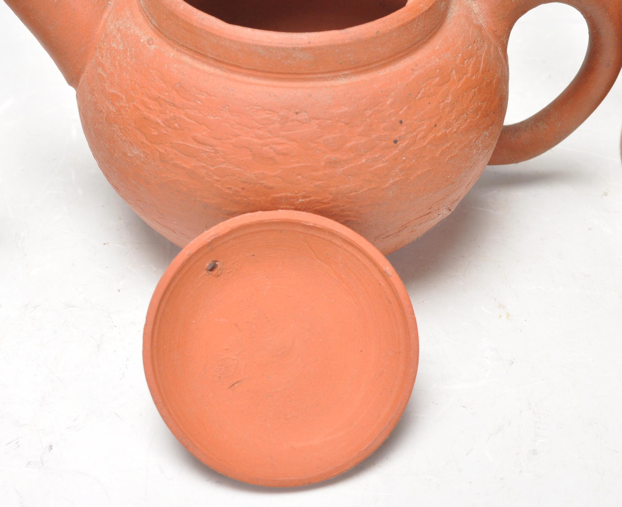 A collection of Chinese yixing teapots each of red clay terracotta form. To include a cylindrical - Image 7 of 12