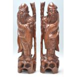 A good pair of Antique Chinese root carvings of wise men. Each figure having glass set eyes with