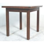 A vintage early 20th Century oak draw leaf dining table raised on straight leg supports having
