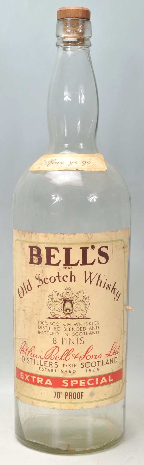 A large vintage advertising Bell's Old Scotch Whisky bottle.