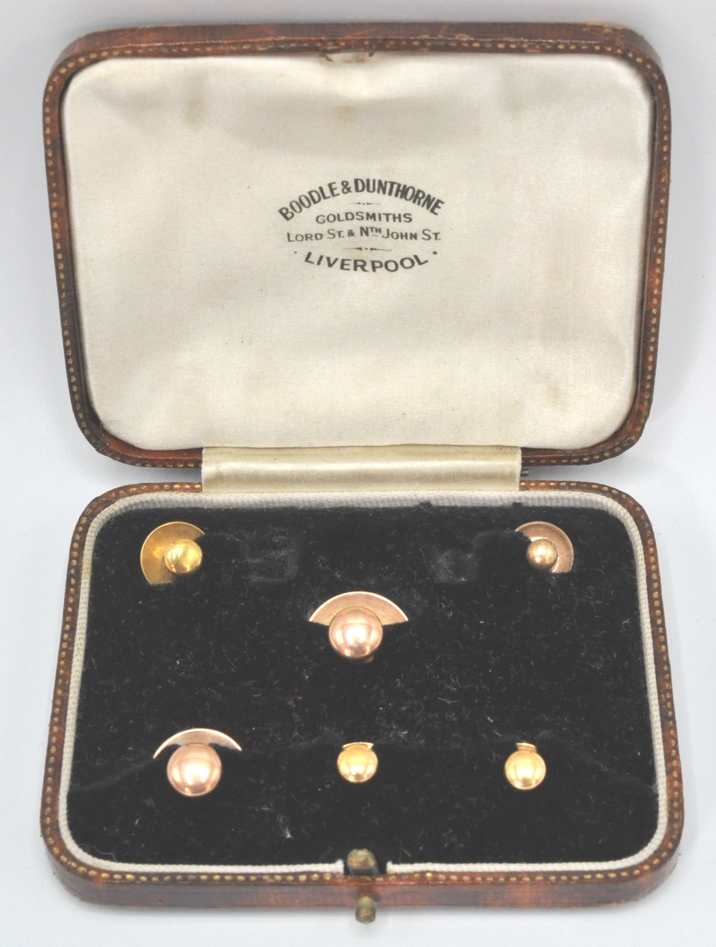A set of gold collar studs to include three marked