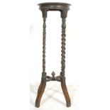 A 19th Century Victorian oak plant stand / jardiniere / torchere. The stand having a round top
