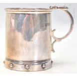 An early 20th Century Edwardian silver hallmarked cup having a scrolled handle and ball decoration