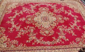 An early 20th Century Persian / Islamic floor rug having red and cream ground with a central