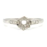 A 1930's platinum ring mount having diamond set shoulders. Marked PLAT. Total weight 2.45g. Size L.5