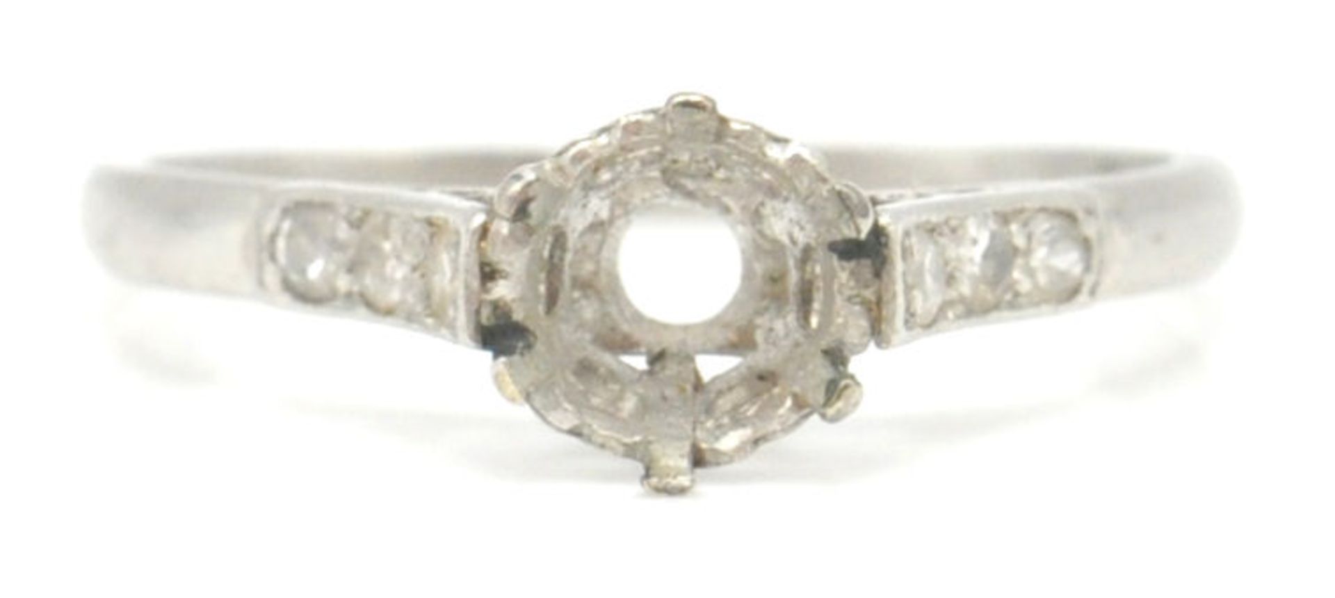 A 1930's platinum ring mount having diamond set shoulders. Marked PLAT. Total weight 2.45g. Size L.5