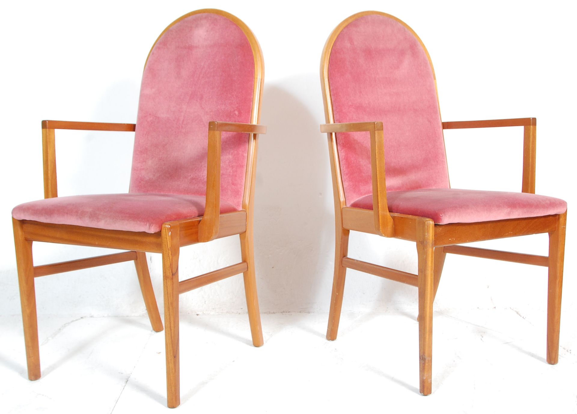 A matching pair of retro mid 20th Century teak framed dining carver chairs / armchairs having arched