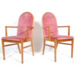 A matching pair of retro mid 20th Century teak framed dining carver chairs / armchairs having arched