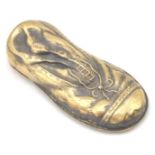 A contemporary brass vesta case in the shape of an old boot, having a match striker to the base.