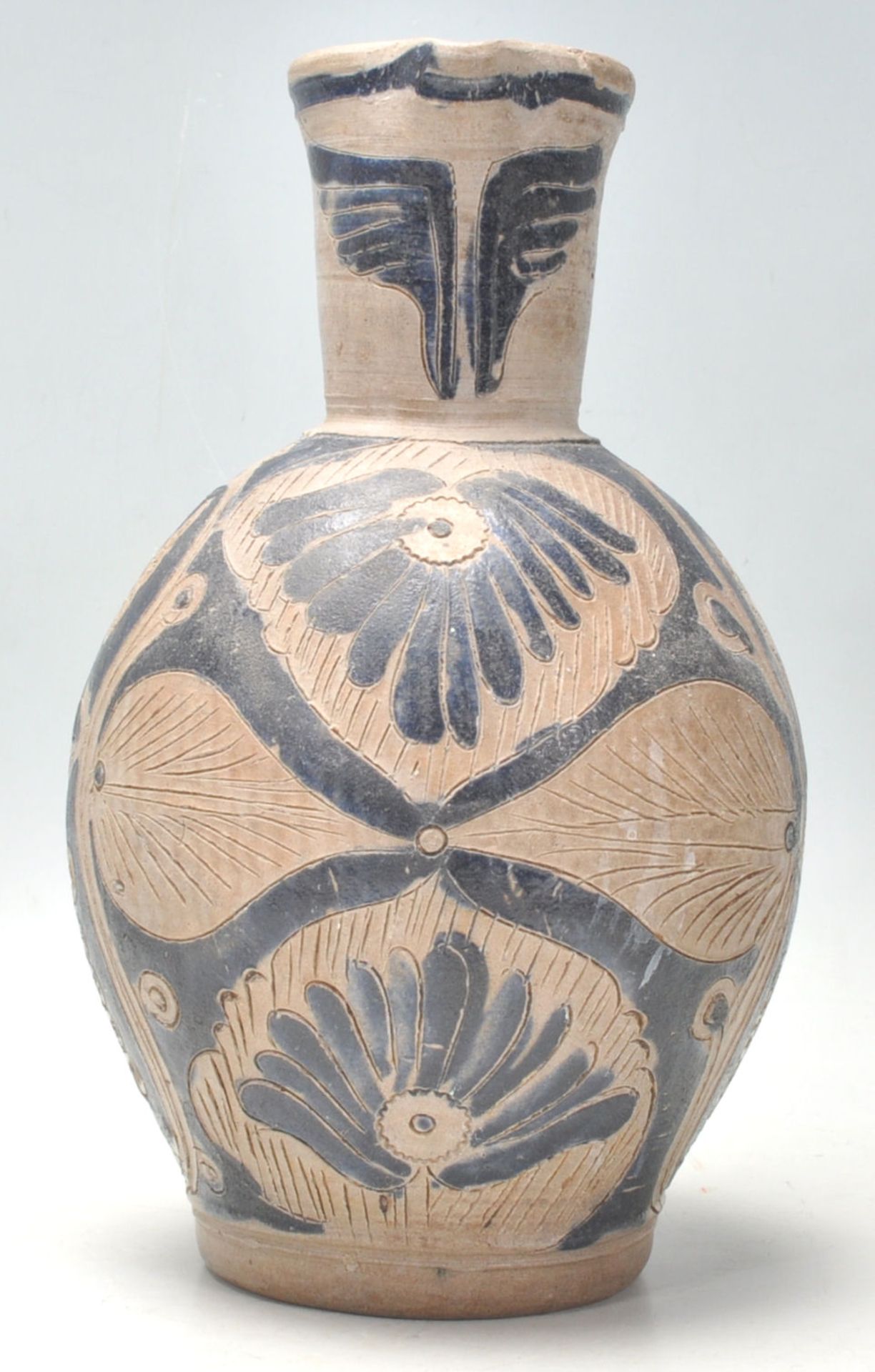 An antique handmade earthenware jug, possibly North American /  Navajo having incised abstracted