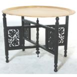 An early 20th Century asiatic - anglo colonial folding Binares brass opium table. The ebonised