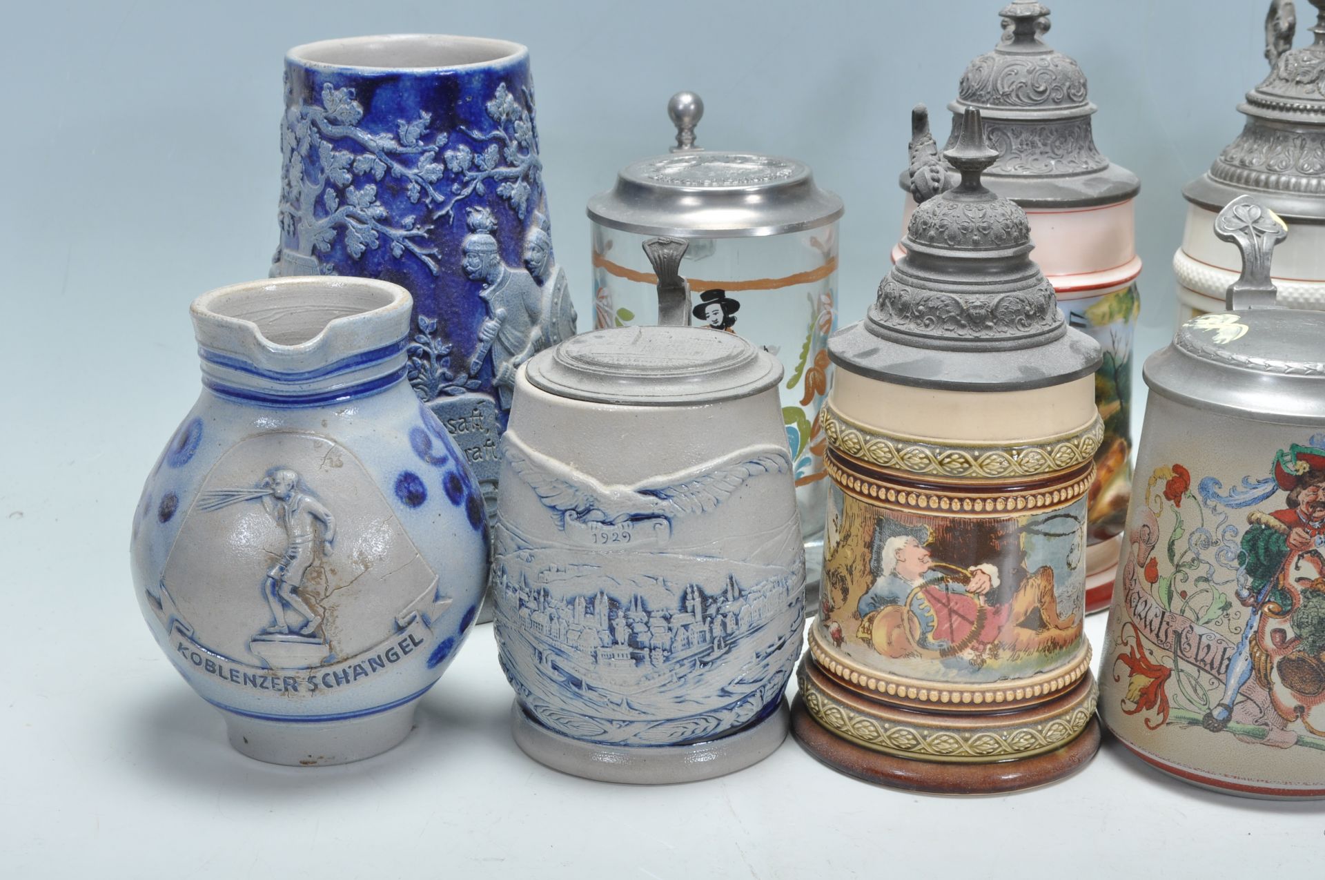 A collection of 20th Century German ceramic stein drinking glasses, many having raised blue and grey - Bild 5 aus 9