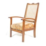 An Edwardian 20th Century mahogany cane-backed bergere bedroom chair with a fabric lined cushion set