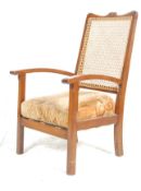 An Edwardian 20th Century mahogany cane-backed bergere bedroom chair with a fabric lined cushion set