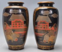 A matching pair of mid 20th Century Japanese stoneware baluster vases finished in black with hand