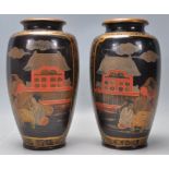 A matching pair of mid 20th Century Japanese stoneware baluster vases finished in black with hand