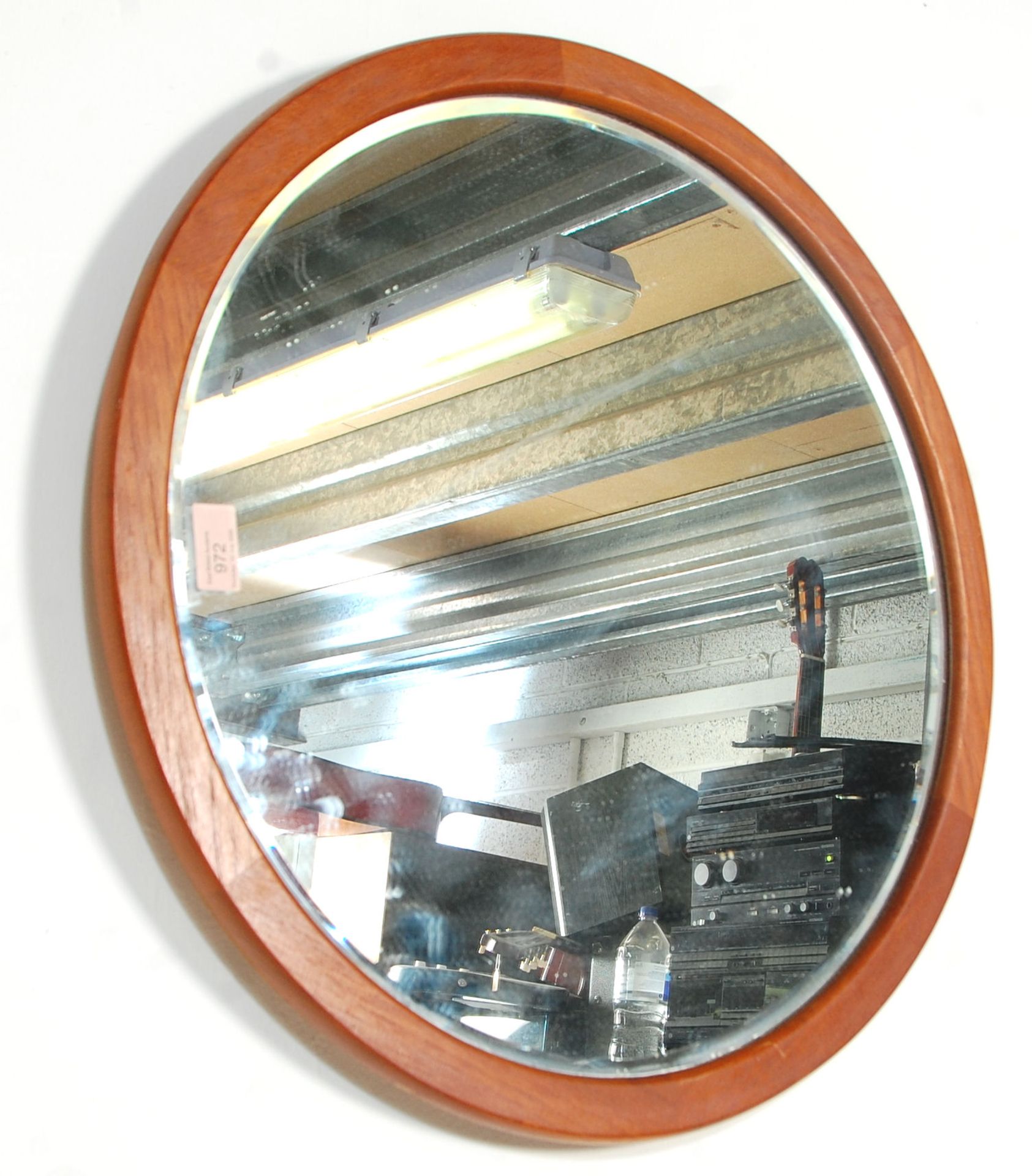 A vintage retro mid 20th Century circular teak framed hanging wall mirror having a bevelled edge