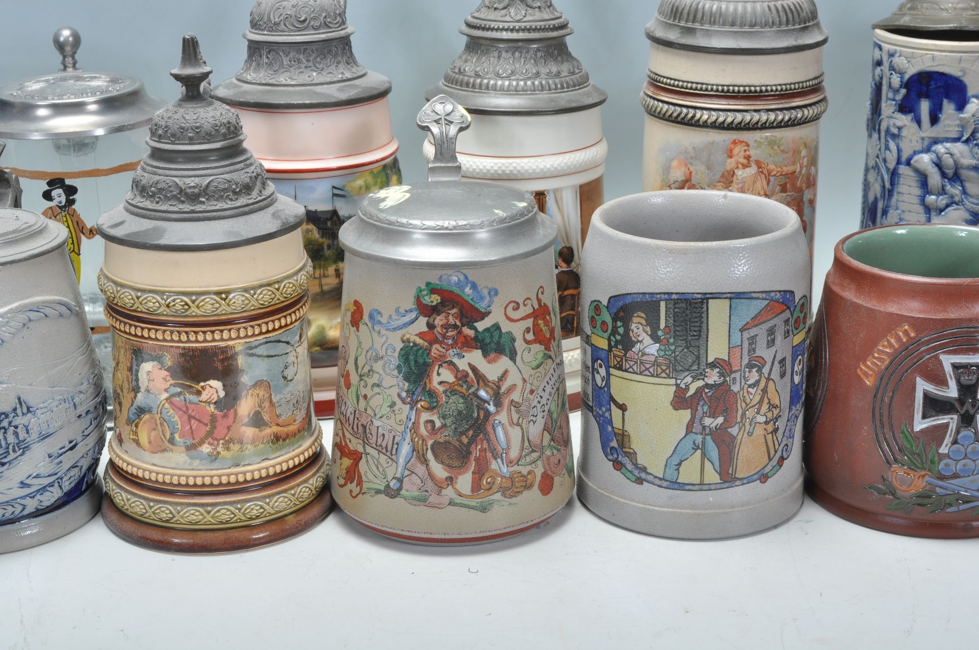 A collection of 20th Century German ceramic stein drinking glasses, many having raised blue and grey - Bild 6 aus 9