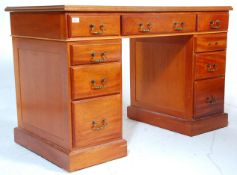 A 20th Century antique style twin pedestal desk having three drawers to the frieze with banks of