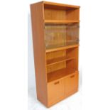 A retro mid 20th Century teak wood room unit having open shelves with a glazed door compartment